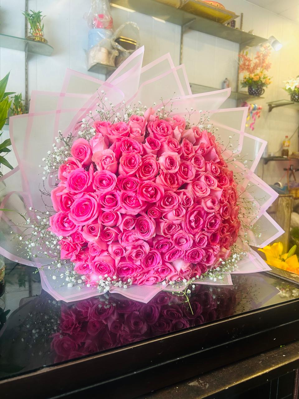 Front view of a grand bouquet of 50 bright pink roses