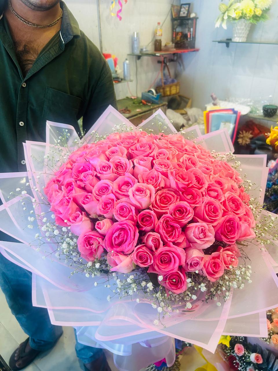 Close-up view of the 50 pink rose bouquet with baby's breath