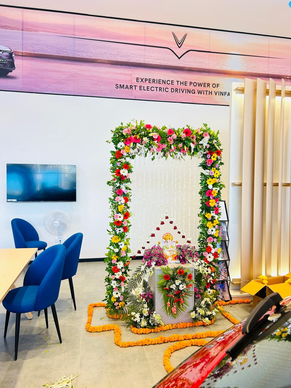 Ganesh Ji flower backdrop and selfie point inside a Noida Sector 63 car showroom