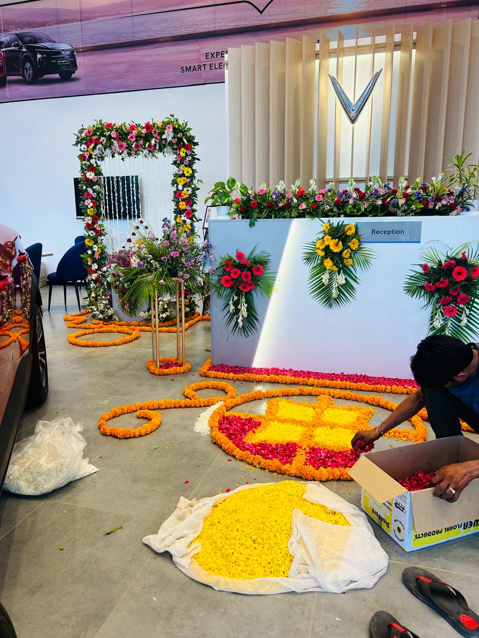Car showroom reception decorated with fresh flowers and marigold rose petal rangoli