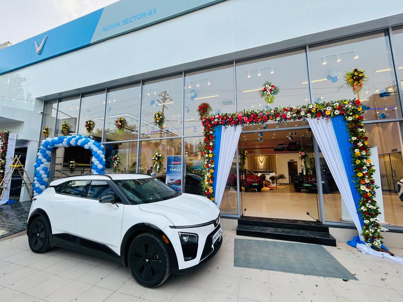 Completed car showroom entrance flower decoration with blue and white drapes in Noida Sector 63