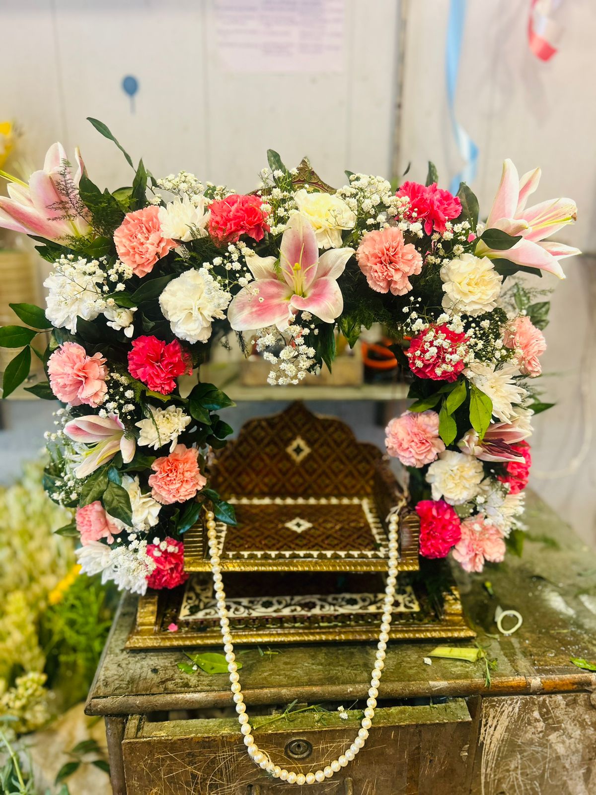 Pink lily and carnation flower jhula for Laddu Gopal home temple on Janmashtami