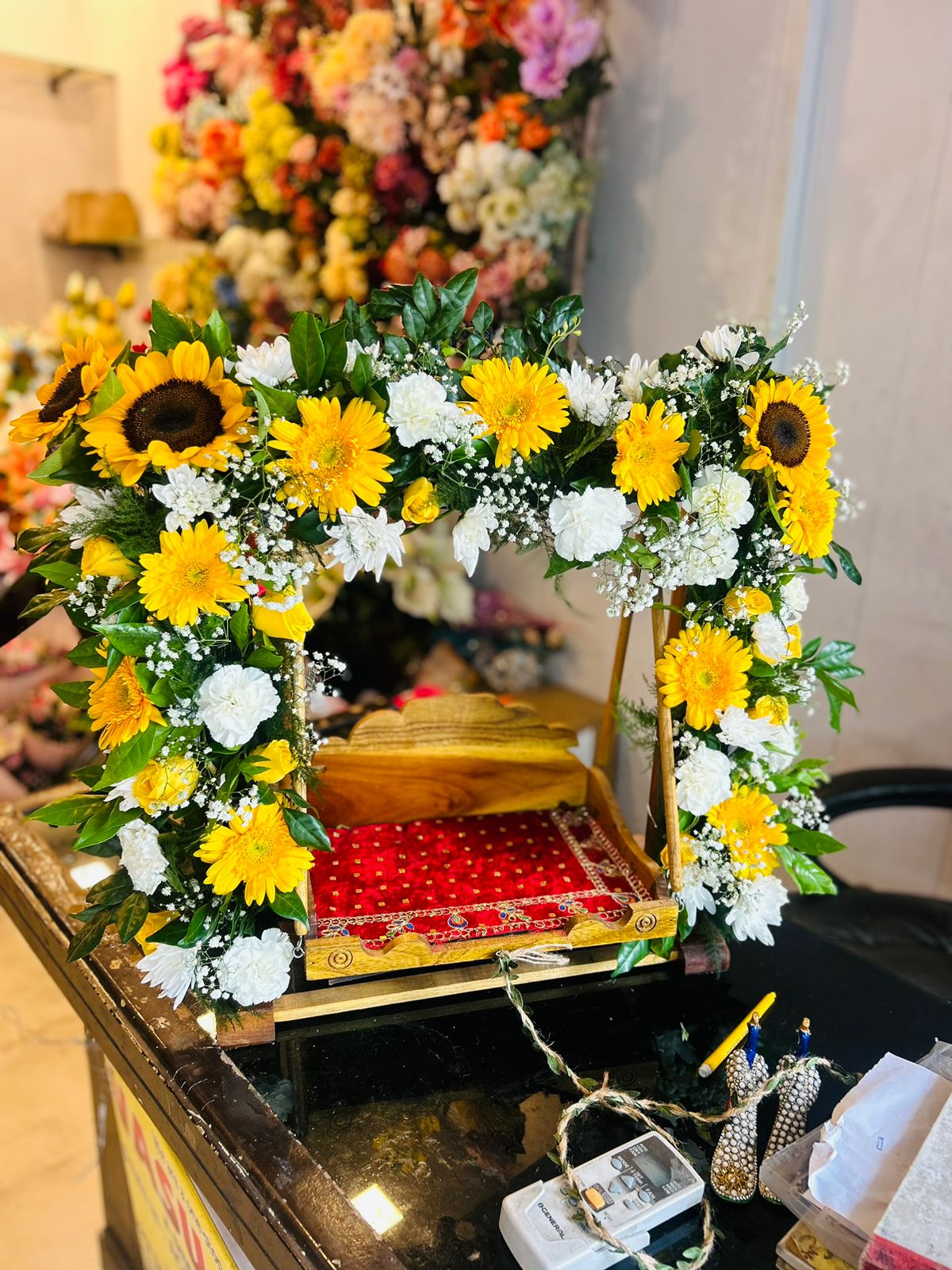 Yellow sunflower and white flower Laddu Gopal jhula decoration for Janmashtami in Raj Nagar Extension