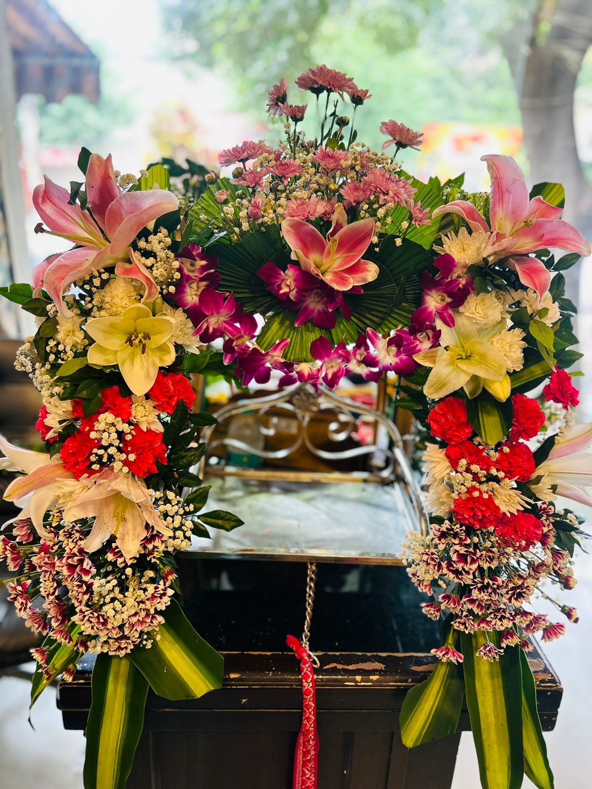 Premium pink lily orchid and mixed flower Janmashtami jhula decoration for Wave City Ghaziabad
